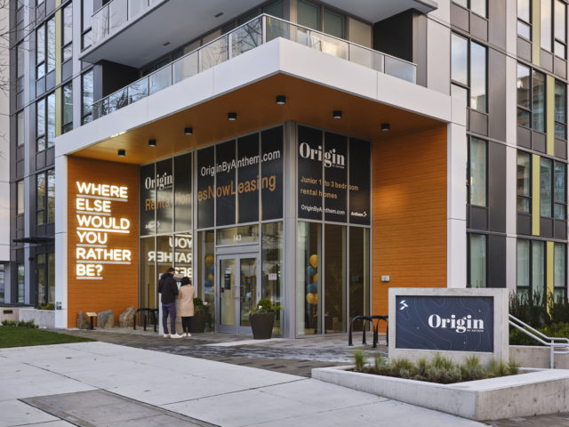 LED Neon sign mounted on the wall of the entrance to a building that reads where else would you rather be?